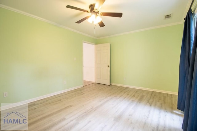 spare room featuring ceiling fan, ornamental molding, and light hardwood / wood-style flooring