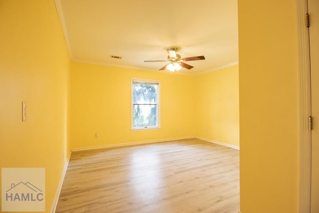 spare room with ceiling fan, wood-type flooring, and ornamental molding