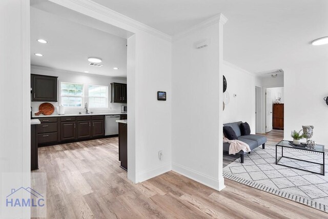 550 Brogdon Rd, Guyton, GA 31312 - kitchen with ornamental molding, dishwasher, light countertops, light wood-type flooring, and a sink
