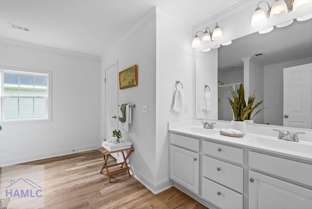 550 Brogdon Rd, Guyton, GA 31312 - bathroom with crown molding, wood finished floors, double vanity, baseboards, and a shower