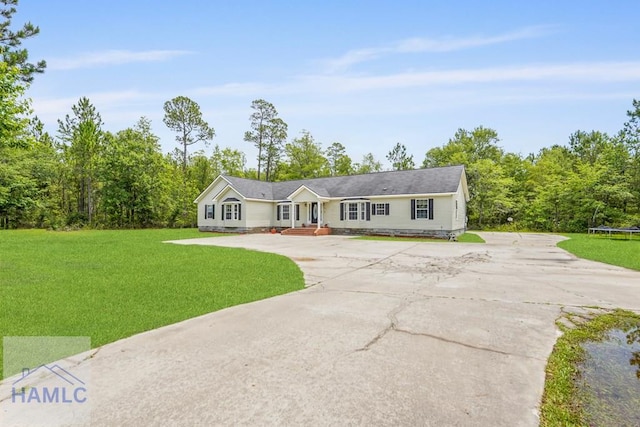550 Brogdon Rd, Guyton, GA 31312 - single story home with a front lawn, driveway, and a trampoline