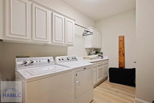 645 Littlefield St, Jesup, GA 31546 - laundry area featuring cabinet space, washing machine and clothes dryer, light wood finished floors, and a textured ceiling