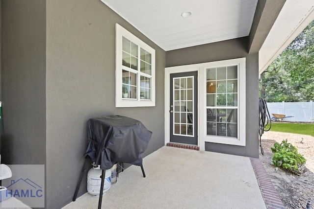 645 Littlefield St, Jesup, GA 31546 - view of exterior entry with stucco siding and a patio area