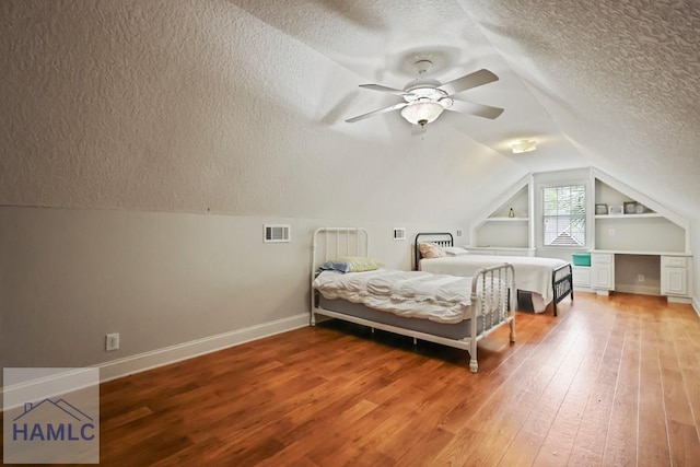 645 Littlefield St, Jesup, GA 31546 - bedroom with a textured ceiling, light wood-style floors, vaulted ceiling, and ceiling fan
