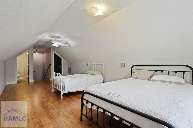 645 Littlefield St, Jesup, GA 31546 - bedroom with wood finished floors, vaulted ceiling, a textured ceiling, and ceiling fan
