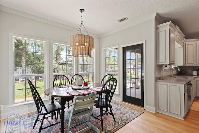 645 Littlefield St, Jesup, GA 31546 - dining room with light wood-style floors, a chandelier, and crown molding