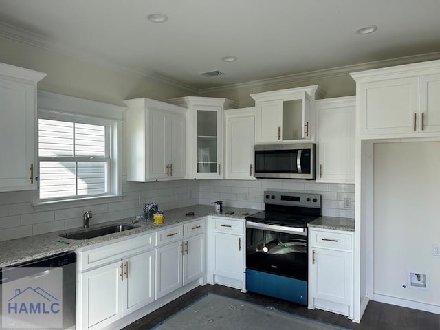 kitchen featuring light stone countertops, white cabinets, and stainless steel appliances