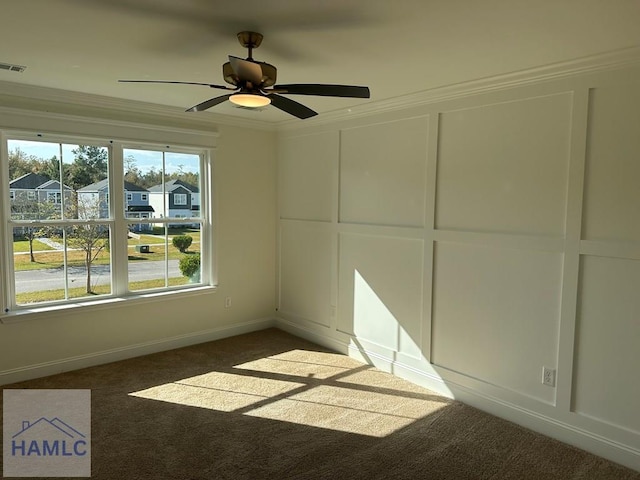 unfurnished room with dark carpet, ceiling fan, and crown molding