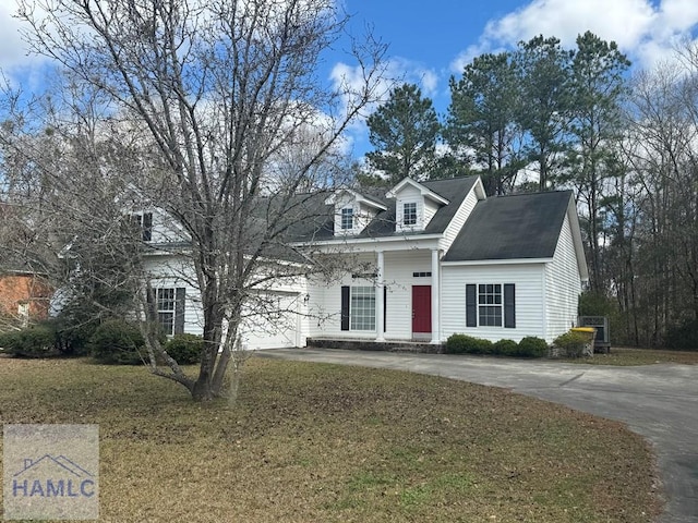 cape cod home featuring a garage, driveway, and a front yard