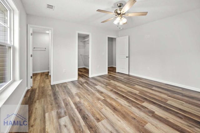 unfurnished dining area featuring dark hardwood / wood-style flooring, a textured ceiling, and an inviting chandelier