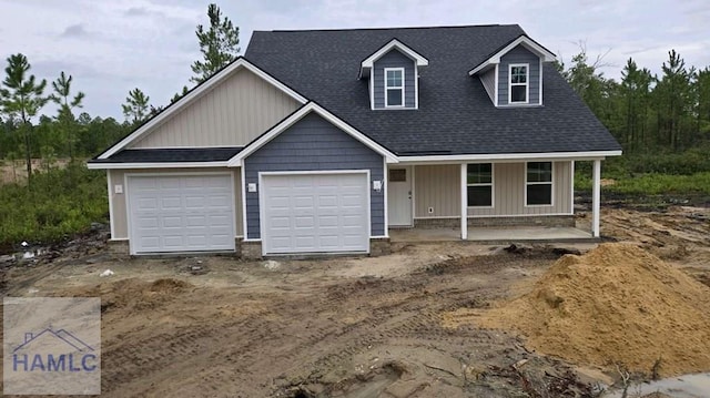 view of front of home with a porch and a garage