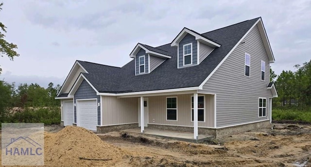 view of front of property with covered porch and a garage