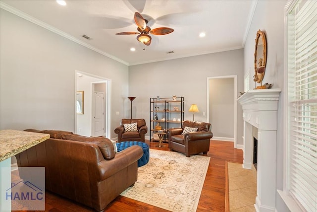190 Sandpiper Rd, Midway, GA 31320 - living room featuring a ceiling fan, wood finished floors, recessed lighting, a fireplace with flush hearth, and crown molding