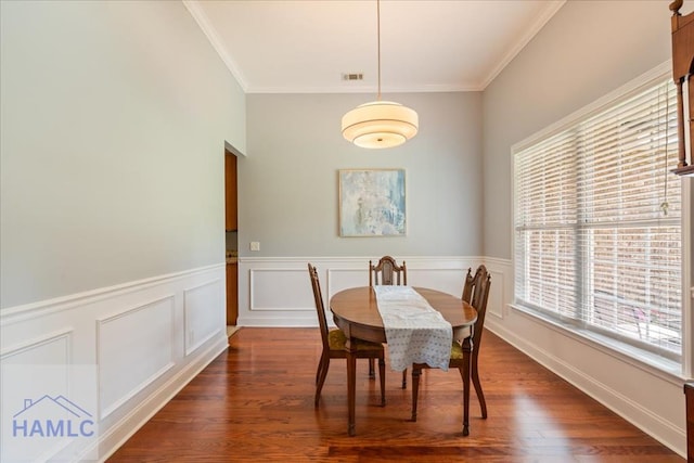 190 Sandpiper Rd, Midway, GA 31320 - dining space featuring ornamental molding, a wainscoted wall, and wood finished floors