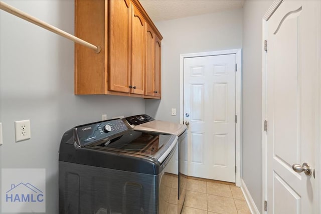 190 Sandpiper Rd, Midway, GA 31320 - laundry room with washer and dryer, cabinet space, light tile patterned floors, baseboards, and a textured ceiling