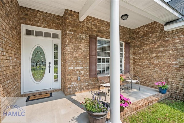 190 Sandpiper Rd, Midway, GA 31320 - doorway to property with brick siding and a porch