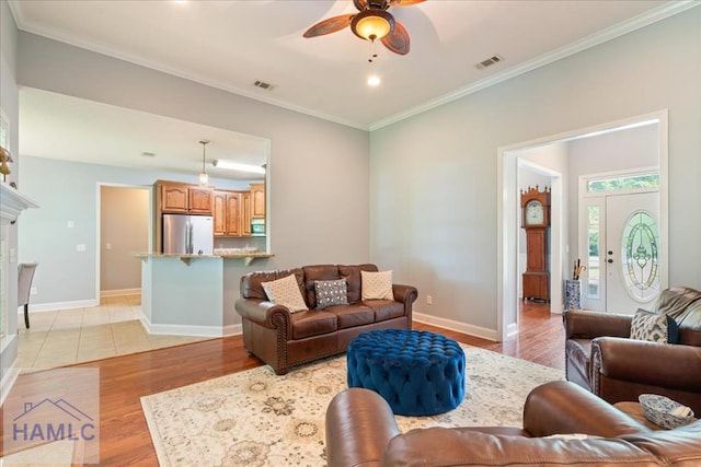 190 Sandpiper Rd, Midway, GA 31320 - living area featuring a ceiling fan, light wood-style floors, crown molding, baseboards, and a tile fireplace