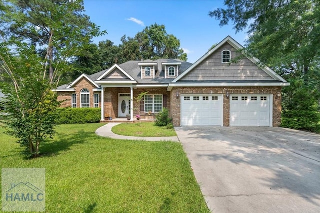 190 Sandpiper Rd, Midway, GA 31320 - view of front of home featuring a garage, brick siding, a front lawn, concrete driveway, and a porch
