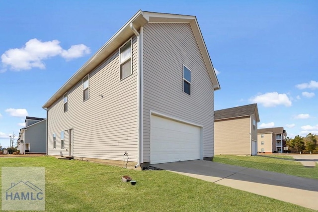 view of side of home with a yard and a garage