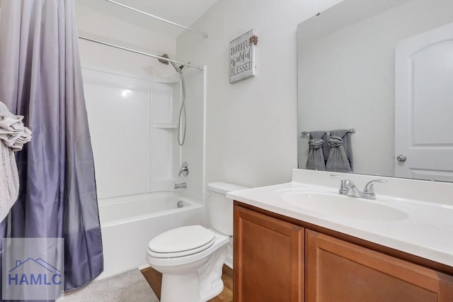 full bathroom with vanity, shower / tub combo, and toilet