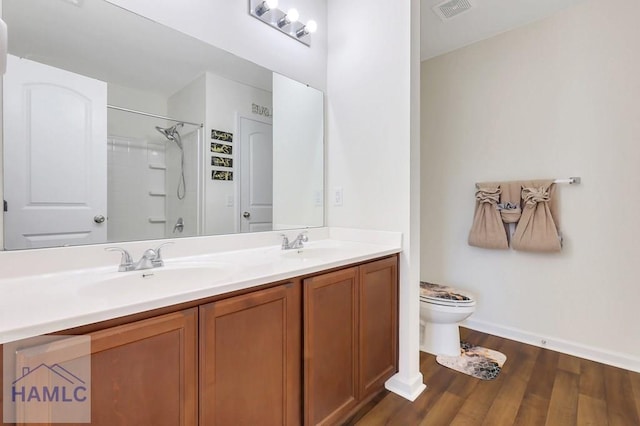 full bathroom featuring vanity, hardwood / wood-style floors,  shower combination, and toilet