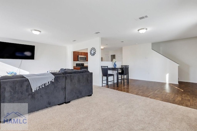 living room with dark hardwood / wood-style flooring