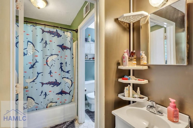 full bathroom featuring shower / bath combination with curtain, toilet, and sink