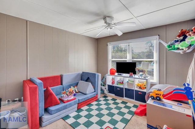 rec room with carpet and ceiling fan