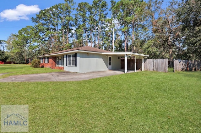 back of property with a yard and a carport