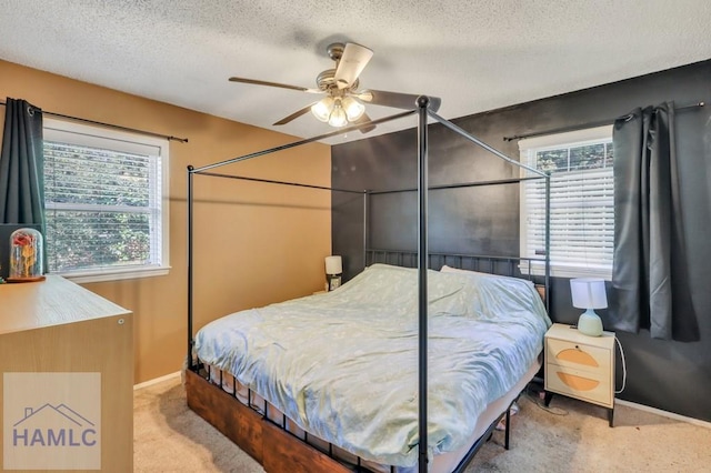 carpeted bedroom with a textured ceiling and ceiling fan