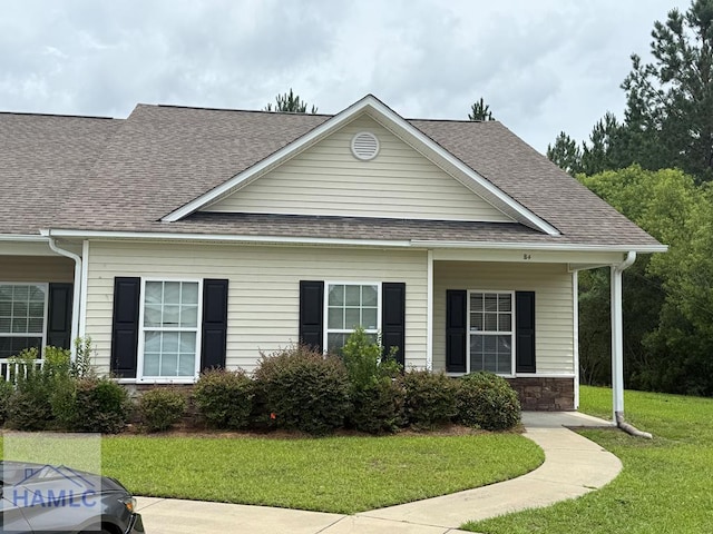 401 Barry Mccaffrey Blvd Unit B4, Hinesville, GA 31313 - view of front of house with a shingled roof, a front lawn, and stone siding
