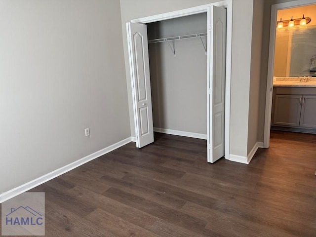 401 Barry Mccaffrey Blvd Unit B4, Hinesville, GA 31313 - unfurnished bedroom featuring dark wood-style floors and a closet