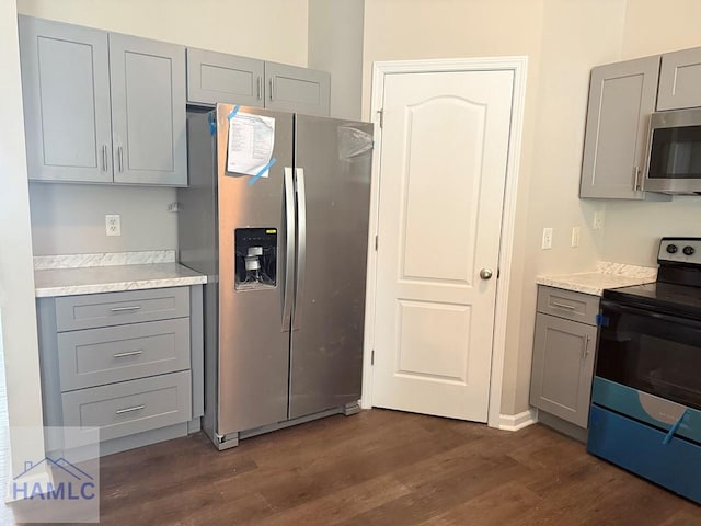 401 Barry Mccaffrey Blvd Unit B4, Hinesville, GA 31313 - kitchen featuring gray cabinetry, appliances with stainless steel finishes, dark wood-style floors, and light countertops