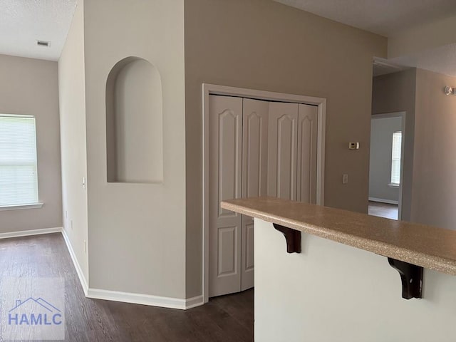401 Barry Mccaffrey Blvd Unit B4, Hinesville, GA 31313 - kitchen featuring dark wood-style flooring, light countertops, and a kitchen breakfast bar
