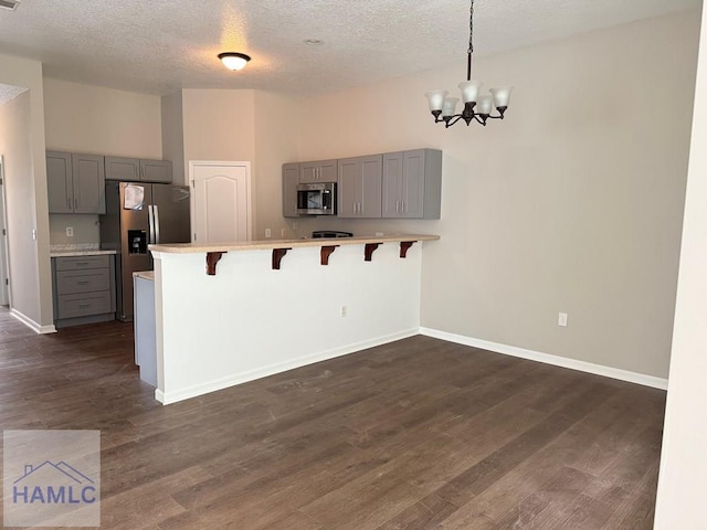 401 Barry Mccaffrey Blvd Unit B4, Hinesville, GA 31313 - kitchen with gray cabinets, stainless steel appliances, a peninsula, light countertops, and a textured ceiling