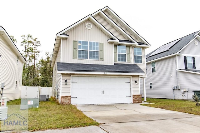 view of front of property featuring a garage, a front lawn, and central air condition unit