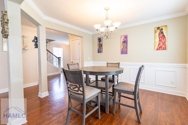 dining room featuring crown molding, dark hardwood / wood-style flooring, and a chandelier