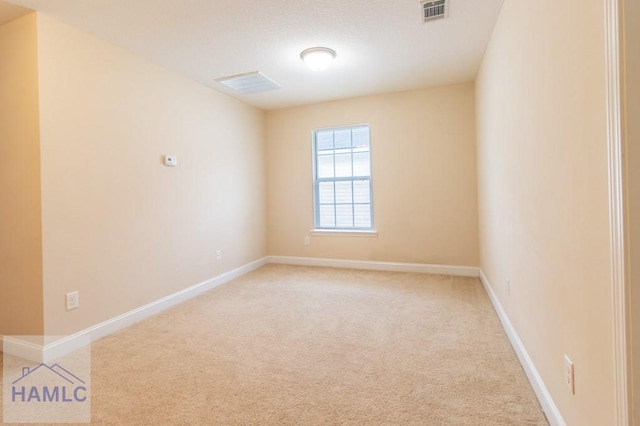 spare room with light colored carpet