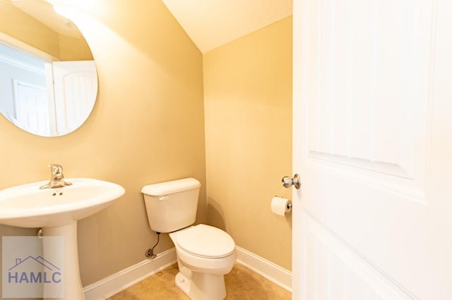 bathroom featuring tile patterned floors, toilet, and sink