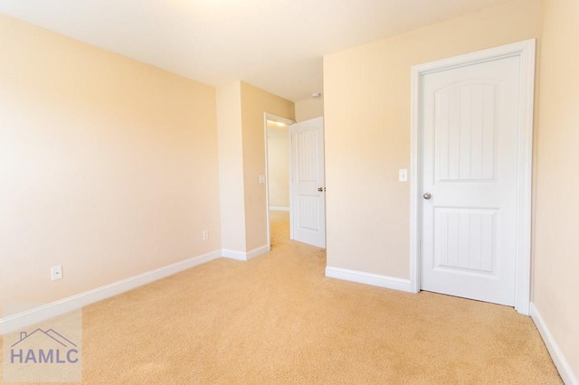 unfurnished bedroom with light colored carpet