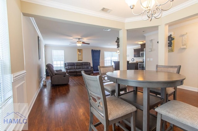 dining space with ceiling fan with notable chandelier, dark hardwood / wood-style floors, and ornamental molding