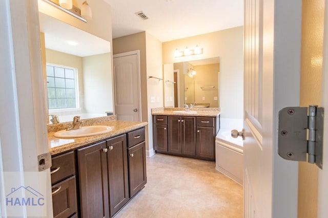 bathroom featuring a bathing tub and vanity