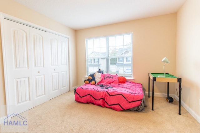 bedroom with light carpet and a closet