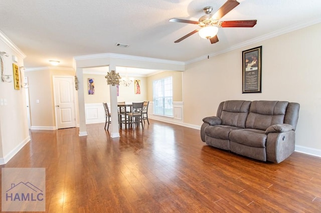 living room featuring crown molding, wood-type flooring, and ceiling fan with notable chandelier