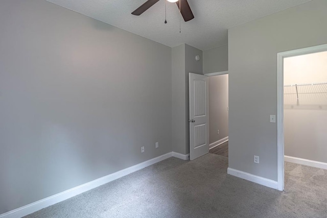 404 Talmadge Rd, Allenhurst, GA 31301 - unfurnished bedroom with a walk in closet, carpet floors, and ceiling fan