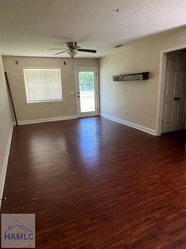 206 Adair St, Jesup, GA 31545 - spare room featuring ceiling fan, dark wood-type flooring, and a textured ceiling