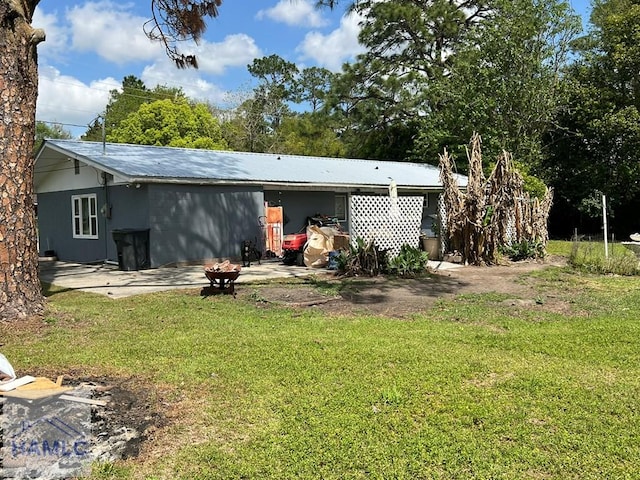206 Adair St, Jesup, GA 31545 - rear view of house with a lawn and a metal roof