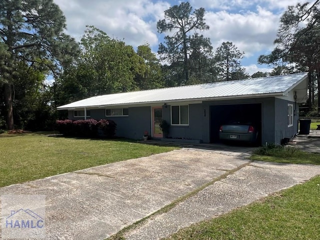 206 Adair St, Jesup, GA 31545 - single story home featuring an attached garage, a front lawn, a metal roof, concrete driveway, and concrete block siding