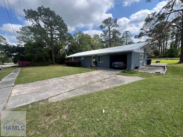 206 Adair St, Jesup, GA 31545 - view of front of house with driveway, a front lawn, a metal roof, and an attached carport