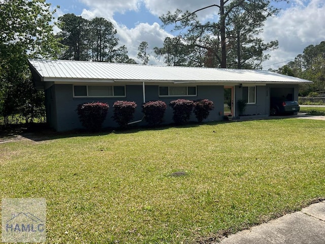 206 Adair St, Jesup, GA 31545 - ranch-style house with an attached garage, a front yard, and a metal roof